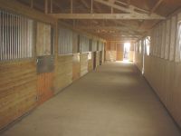 24 x 75 American Barn with the walkway in front of the stables. 