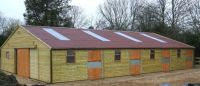 36 x 60 American Barn with 5 - 12 x 12 units on each side. Featuring a red Onduline Roof. 