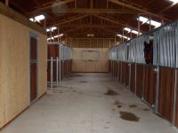 Internal view showing Windsor range fronts. Tack rooms lined with vertical T&G boarding.